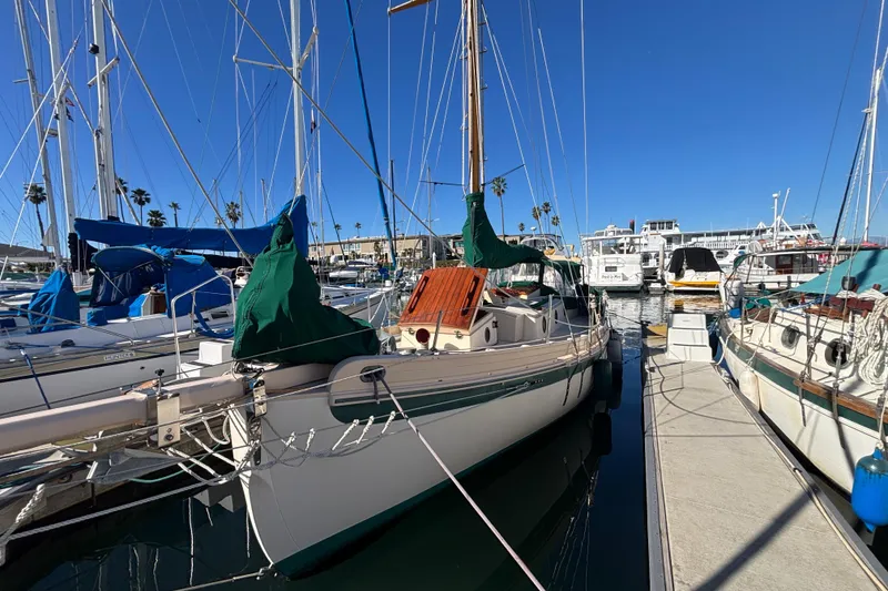 Slide: The Image of 1983 Bristol Channel Cutter 28 sailboat docked in a marina under clear blue skies. - 4