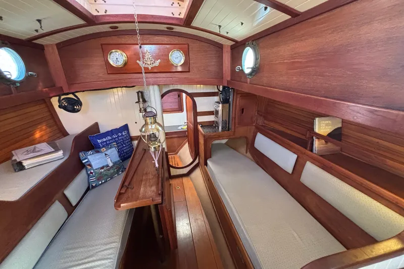 Slide: The Image of Interior of 1983 Bristol Channel Cutter 28, featuring wooden finish and cozy seating. - 43