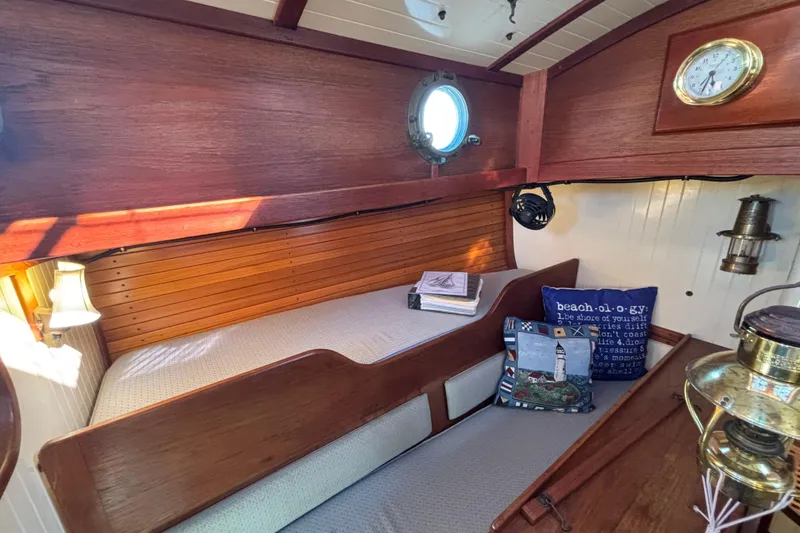 Slide: The Image of Cozy 1983 Bristol Channel Cutter 28 cabin interior with wooden finish and nautical decor. - 44