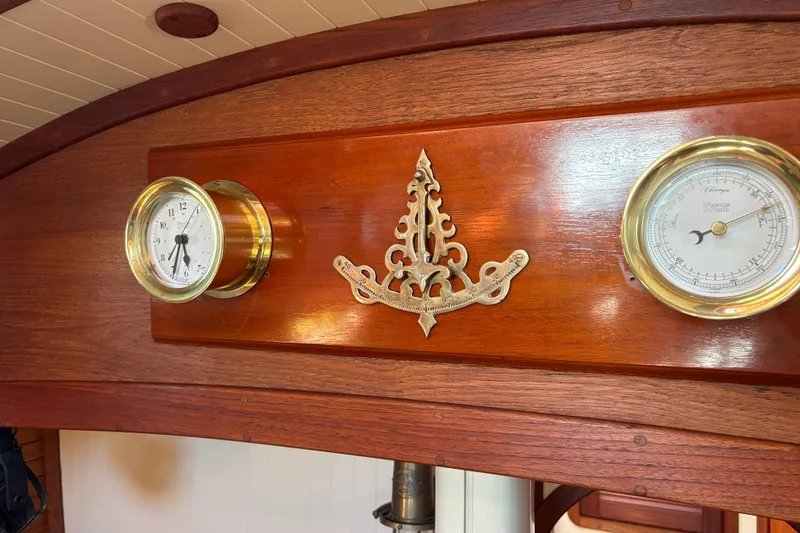 Slide: The Image of Wooden interior of 1983 Bristol Channel Cutter 28 with brass clock and barometer. - 46