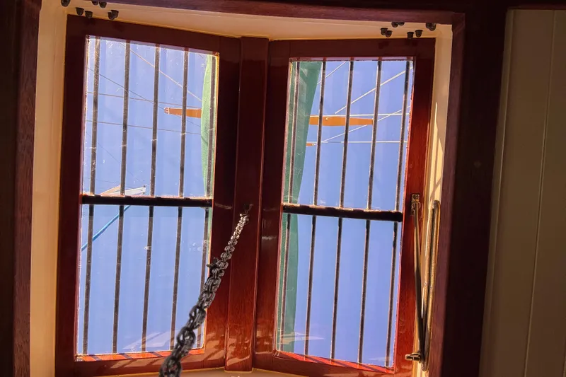 Slide: The Image of Interior view of a 1983 Bristol Channel Cutter 28, showcasing a wooden-framed window. - 47