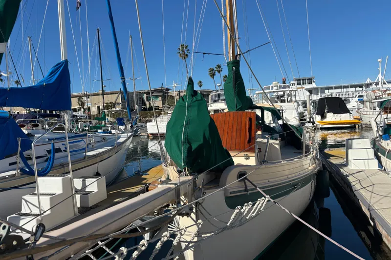 Slide: The Image of 1983 Bristol Channel Cutter 28 docked in a marina, surrounded by other sailboats. - 5