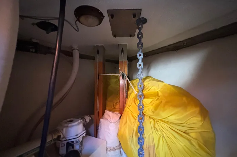 Slide: The Image of Interior of 1983 Bristol Channel Cutter 28 with chain and yellow sail bag. - 57