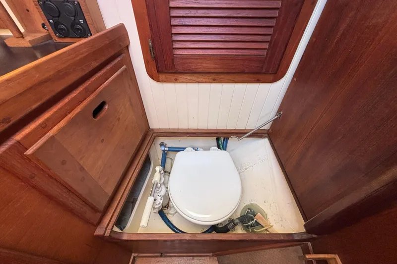 Slide: The Image of 1983 Bristol Channel Cutter 28 boat interior with wooden cabinetry and marine toilet. - 61