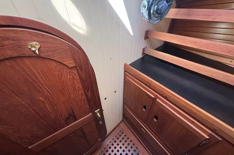 Slide: The Image of Interior of 1983 Bristol Channel Cutter 28, featuring wooden cabinetry and door. - 62