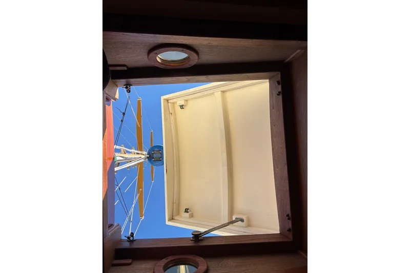 Slide: The Image of View from a 1983 Bristol Channel Cutter 28 hatch, showing mast and clear blue sky. - 64