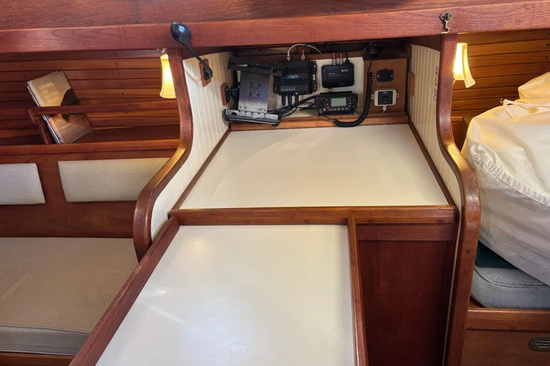 Slide: The Image of Interior of 1983 Bristol Channel Cutter 28 with navigation equipment and cozy seating area. - 70