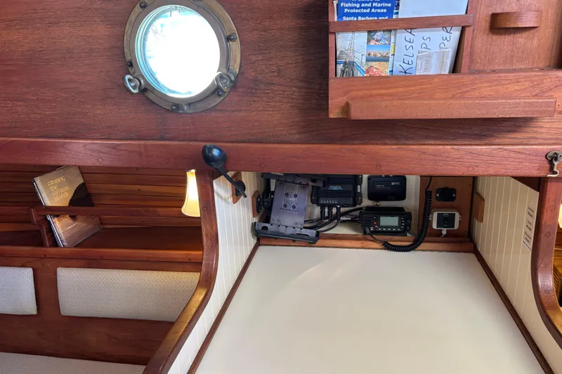 Slide: The Image of Interior of 1983 Bristol Channel Cutter 28, featuring navigation equipment and wooden cabinetry. - 71
