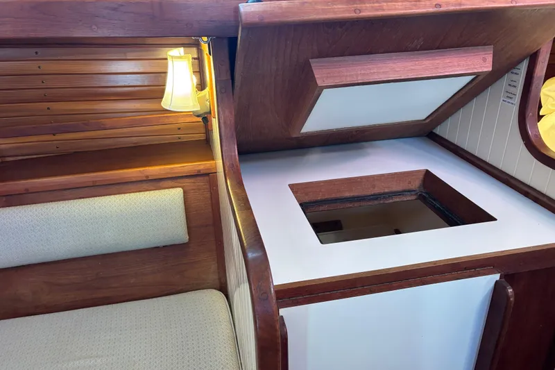Slide: The Image of Interior of 1983 Bristol Channel Cutter 28, featuring wooden cabinetry and seating. - 73