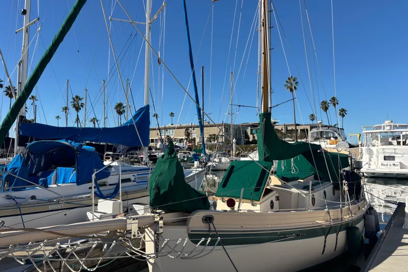 Slide: The Image of 1983 Bristol Channel Cutter 28 sailboat docked in marina with clear blue sky. - 77
