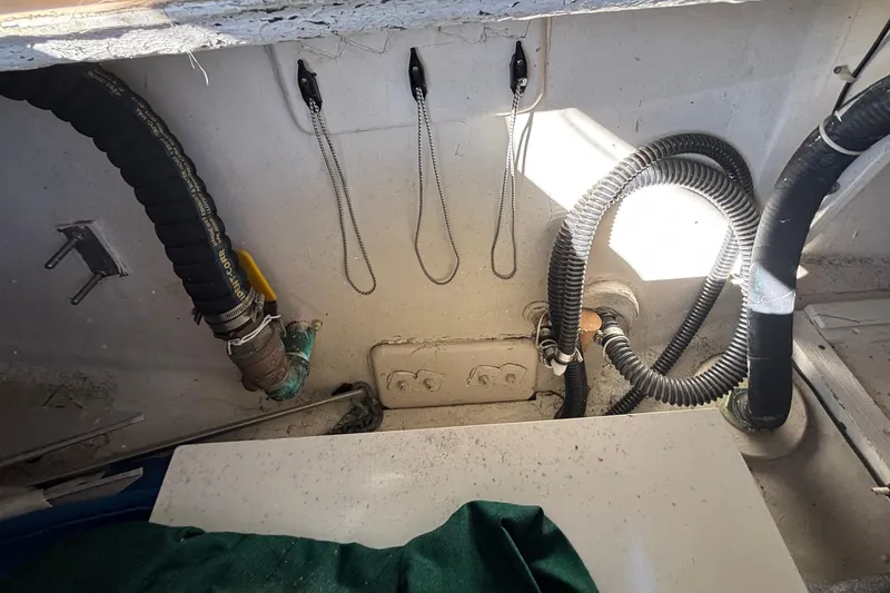 Slide: The Image of Interior view of a 1983 Bristol Channel Cutter 28, showcasing hoses and fittings. - 82