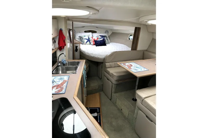 Slide: The Image of Interior of 1997 Maxum 3200 SCR boat with cozy seating and compact kitchen area. - 14