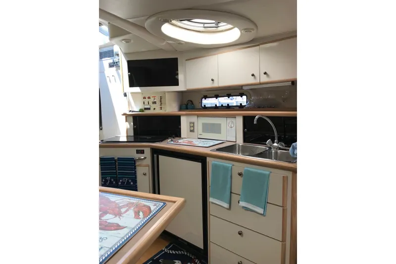 Slide: The Image of Interior of 1997 Maxum 3200 SCR yacht kitchen with sink, microwave, and cabinets. - 5