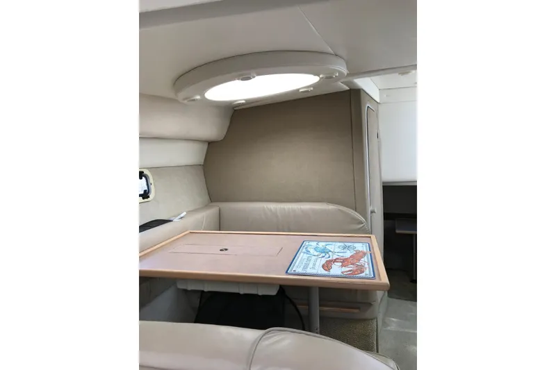 Slide: The Image of 1997 Maxum 3200 SCR cabin interior with table and seating area. - 6