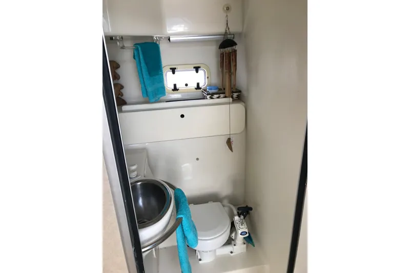 Slide: The Image of Bathroom interior of 1997 Maxum 3200 SCR boat with toilet and sink. - 8