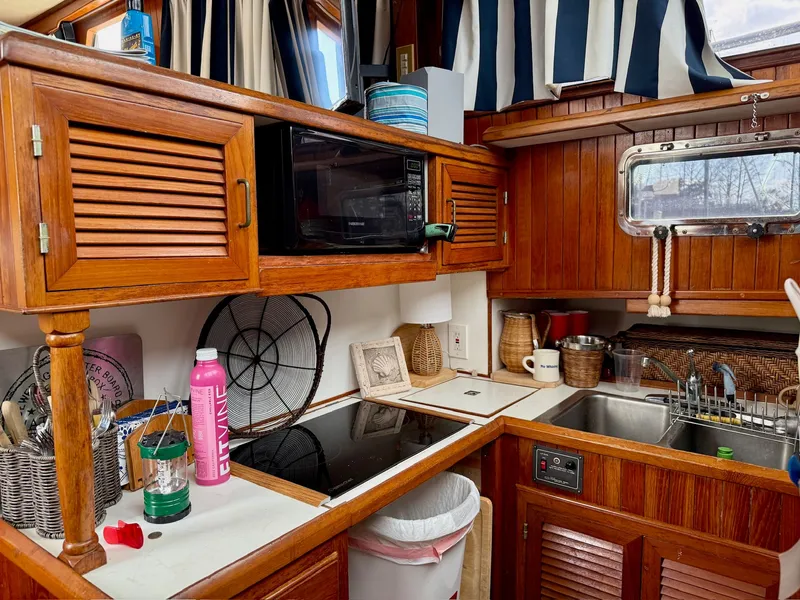 Slide: The Image of 1988 PT 42 Yacht kitchen area with wooden cabinets. - 29