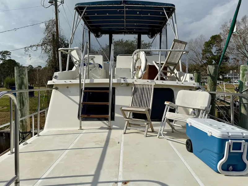 Slide: The Image of 1988 PT 42 Yacht with deck chairs and cooler. - 3