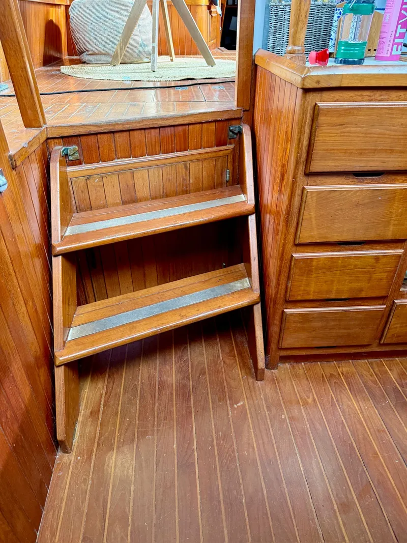 Slide: The Image of Wooden stairs and cabinets inside a 1988 PT 42 Yacht. - 30