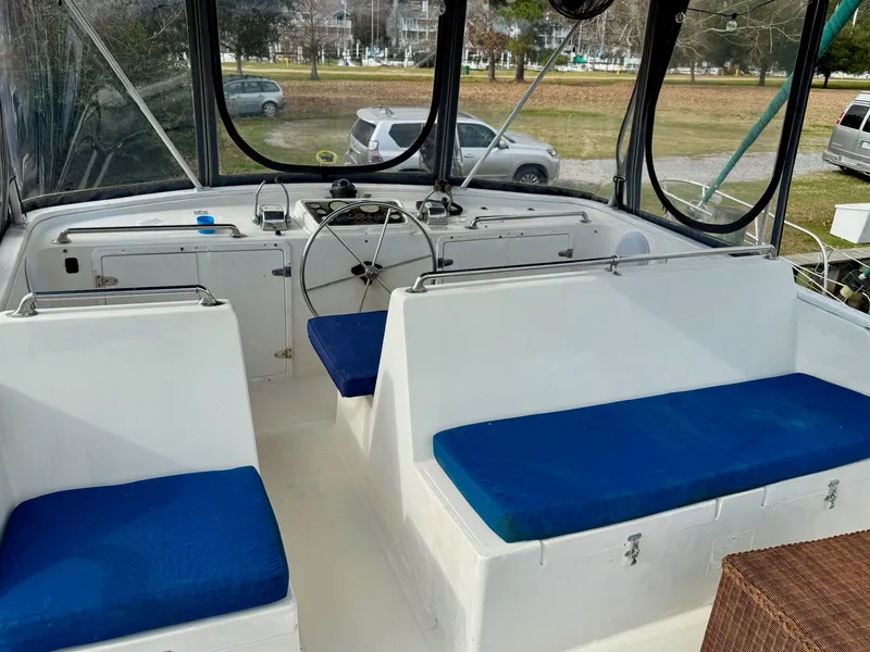 Slide: The Image of Interior of a 1988 PT 42 Yacht with blue seat cushions. - 7
