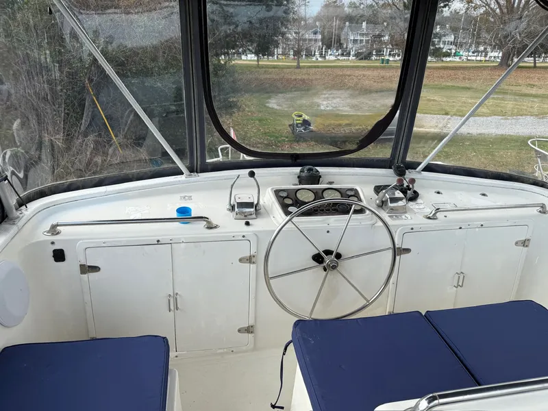 Slide: The Image of Cockpit of a 1988 PT 42 Yacht with blue seat cushions. - 8