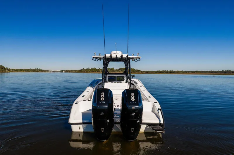 Slide: The Image of 2023 Yellowfin 32 Offshore boat with dual 400 V10 engines on calm water. - 12