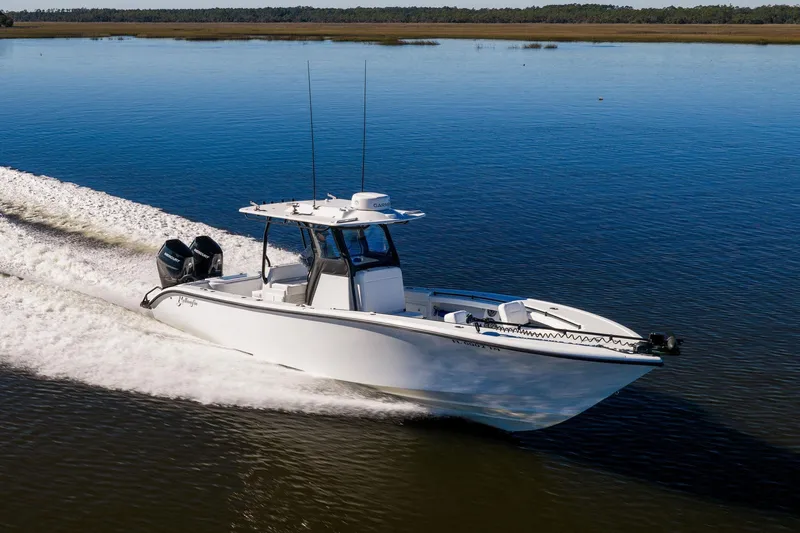 Slide: The Image of 2023 Yellowfin 32 Offshore boat cruising on calm water. - 16