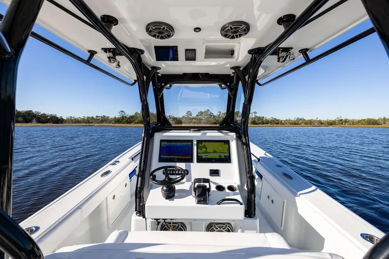 Slide: The Image of 2023 Yellowfin 32 Offshore boat interior with navigation system on calm water. - 33