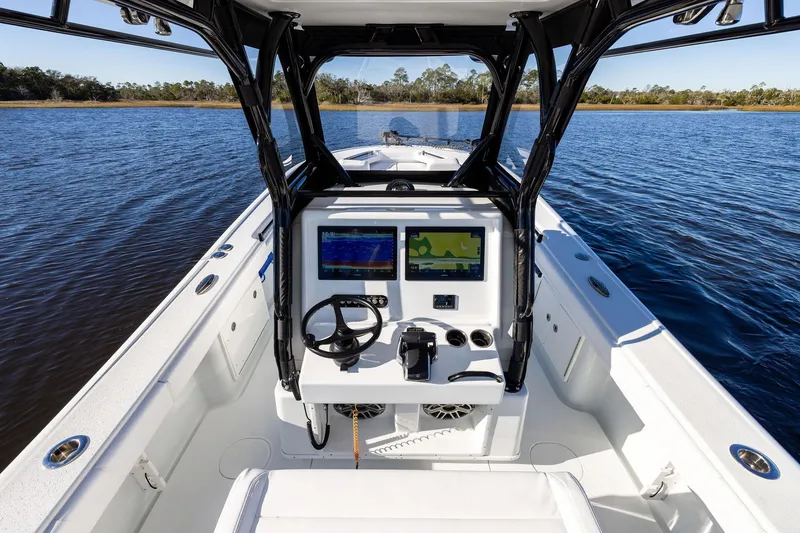 Slide: The Image of 2023 Yellowfin 32 Offshore boat interior with navigation system on calm water. - 34