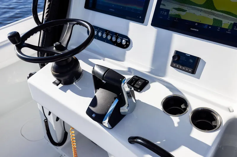 Slide: The Image of 2023 Yellowfin 32 Offshore boat helm with steering wheel and navigation screens. - 36