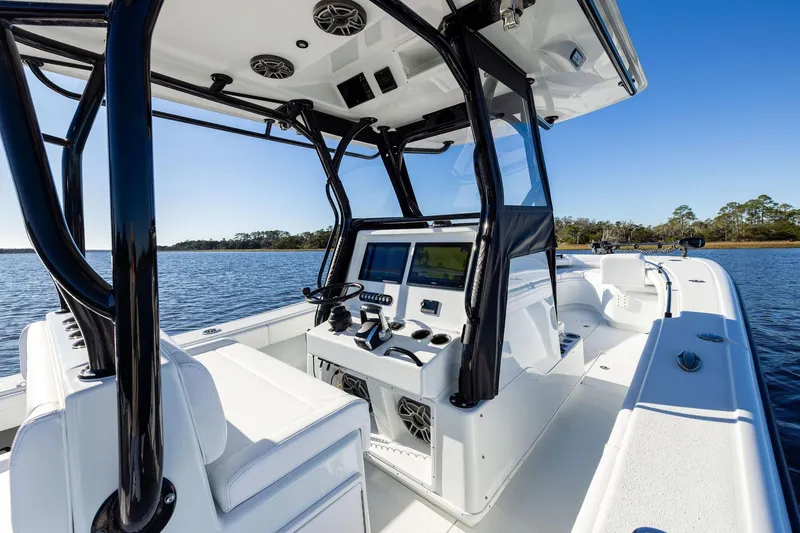 Slide: The Image of 2023 Yellowfin 32 Offshore boat interior with modern console on calm water. - 39