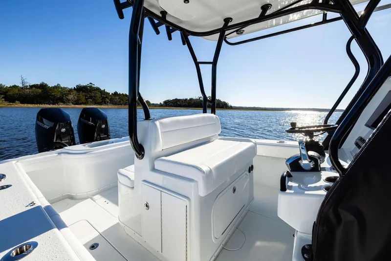 Slide: The Image of 2023 Yellowfin 32 Offshore boat interior with dual engines on a sunny day. - 43
