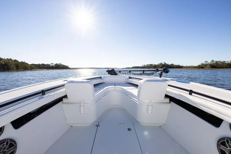 Slide: The Image of 2023 Yellowfin 32 Offshore boat on calm water under bright sun. - 47