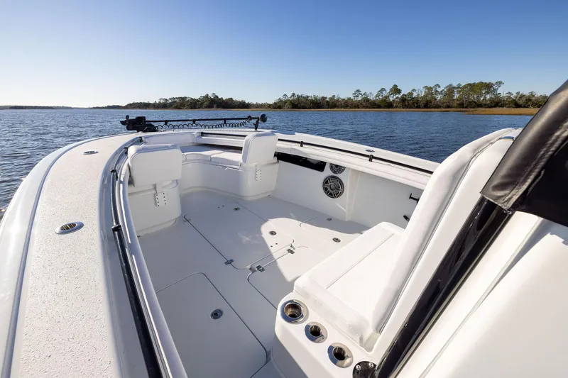 Slide: The Image of 2023 Yellowfin 32 Offshore boat interior with seating, on a calm lake. - 49