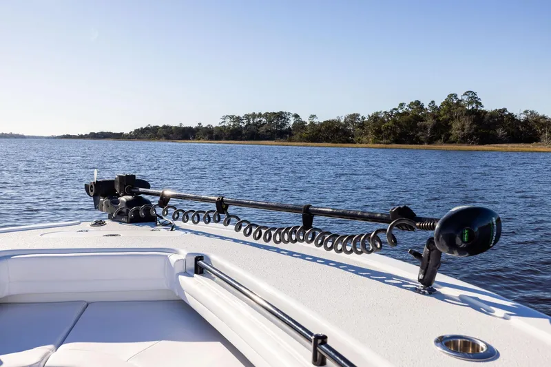 Slide: The Image of 2023 Yellowfin 32 Offshore boat on calm water, featuring a trolling motor. - 51