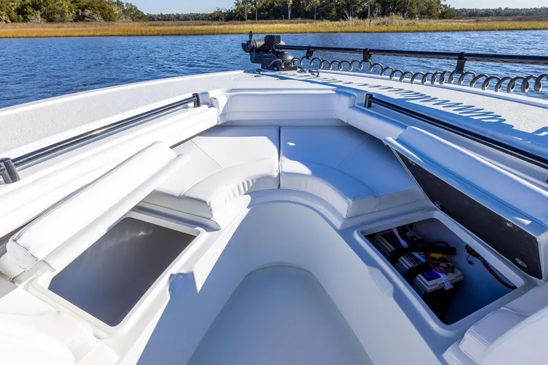 Slide: The Image of 2023 Yellowfin 32 Offshore boat interior with white seating and storage compartments. - 52