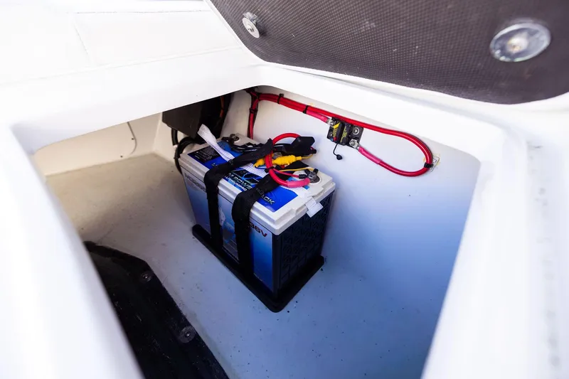 Slide: The Image of 2023 Yellowfin 32 Offshore boat battery compartment with secured wiring. - 54