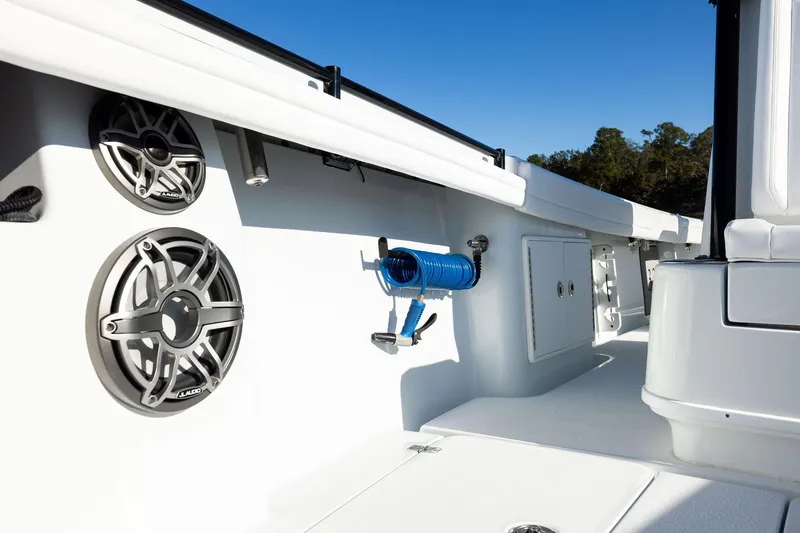 Slide: The Image of 2023 Yellowfin 32 Offshore boat interior with speakers and storage compartments. - 55