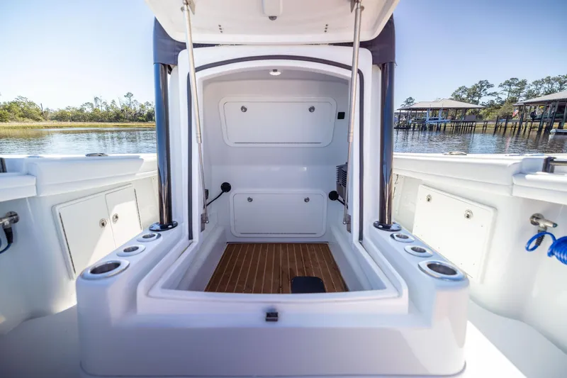 Slide: The Image of 2023 Yellowfin 32 Offshore boat interior with storage compartments and rod holders. - 57
