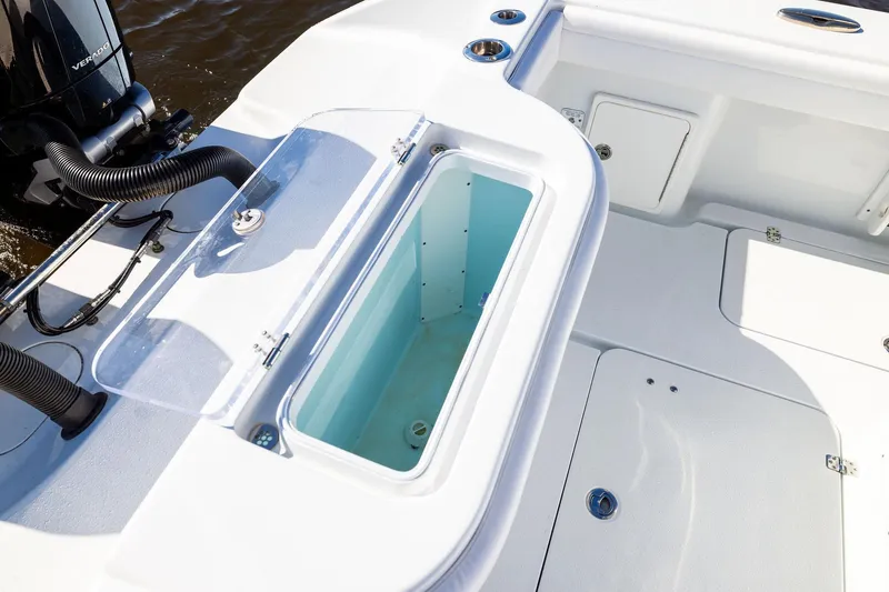 Slide: The Image of 2023 Yellowfin 32 Offshore boat deck with open storage compartment. - 59