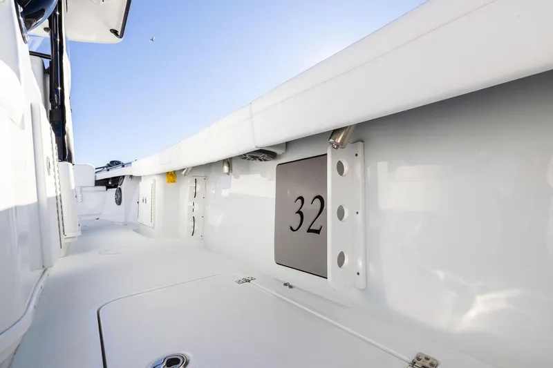 Slide: The Image of 2023 Yellowfin 32 Offshore boat interior with sleek white design and number 32 displayed. - 60