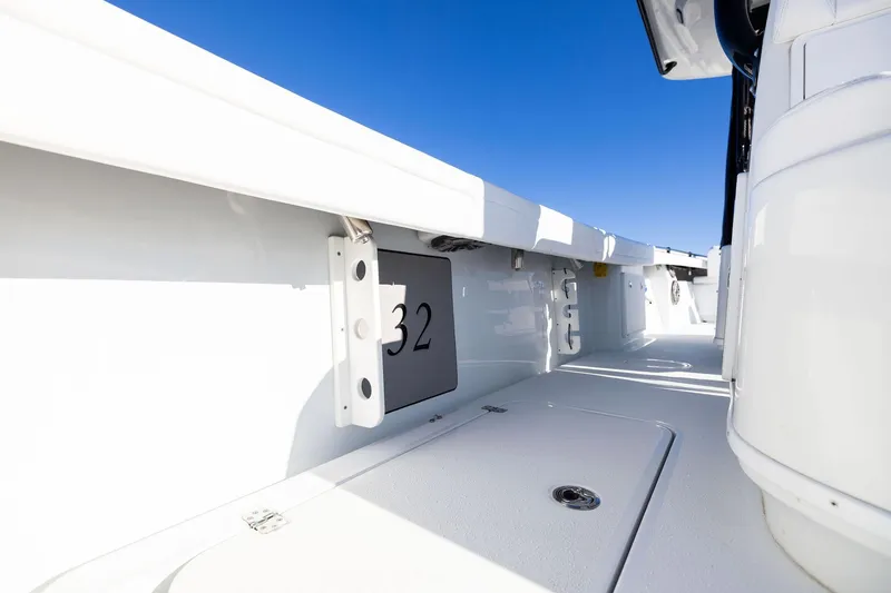 Slide: The Image of 2023 Yellowfin 32 Offshore boat interior with sleek white deck and clear blue sky. - 61