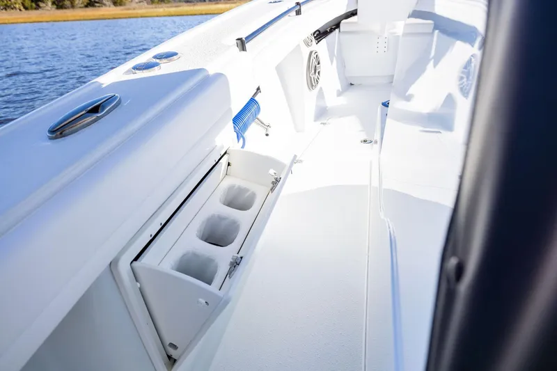 Slide: The Image of 2023 Yellowfin 32 Offshore boat interior with cup holders and sleek design. - 63