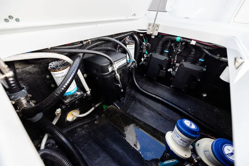 Slide: The Image of Engine compartment of 2023 Yellowfin 32 Offshore boat, showcasing wiring and components. - 65