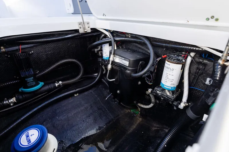 Slide: The Image of 2023 Yellowfin 32 Offshore boat engine compartment with wiring and components. - 67