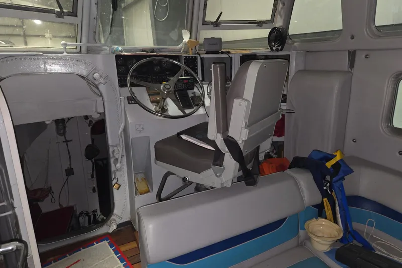 Slide: The Image of Interior of a 1963 Motor Life Boat 44, featuring steering controls and seating. - 10