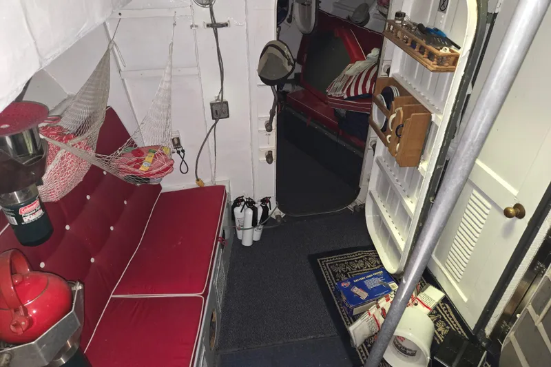 Slide: The Image of Interior of a 1963 Motor Life Boat 44, featuring red seating and storage compartments. - 15