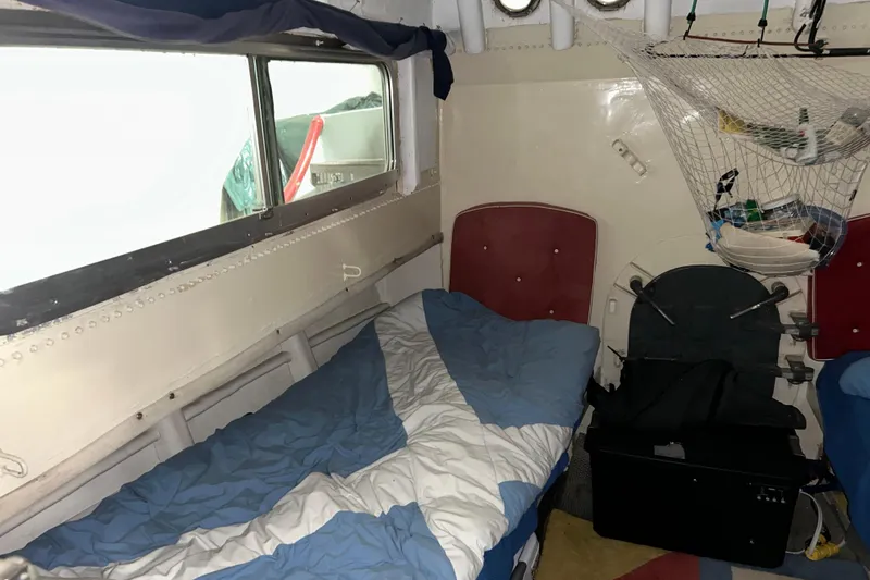 Slide: The Image of Interior of a 1963 Motor Life Boat 44 with a bed and storage net. - 17