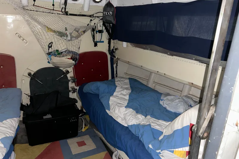 Slide: The Image of Interior of a 1963 Motor Life Boat 44, featuring bunk beds and storage netting. - 18