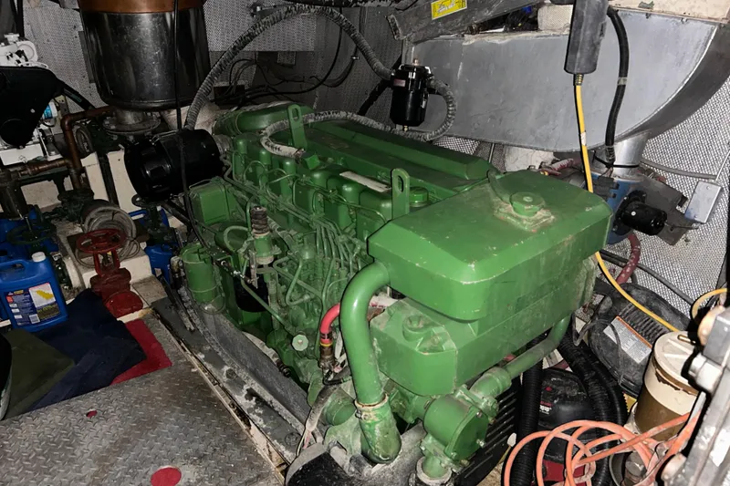 Slide: The Image of Engine room of a 1963 Motor Life Boat 44, featuring a green engine and various components. - 19