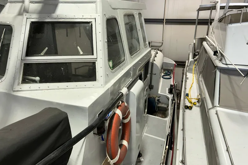 Slide: The Image of 1963 Motor Life Boat 44 in storage, featuring a life preserver and cabin windows. - 7